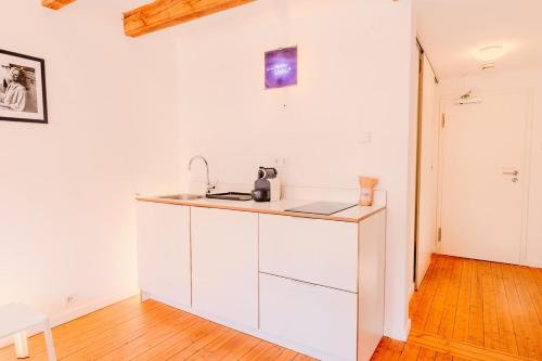 a kitchen with white cabinets and a sink at SOON APT Nr 5 in Simmern