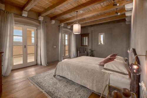a bedroom with a bed and a large window at Tranquil Istria Estate Palazio Clai Winery 8 Bedrooms Spa & Heated Pool in Grožnjan