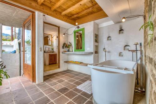 a large bathroom with a tub and a sink at Casa Paloma - Lakefront - Waterfalls - Gardens in San Marcos La Laguna