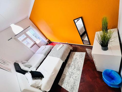 a living room with a couch and a mirror at Amazing rooms in centre of Lisbon, best location in Lisbon