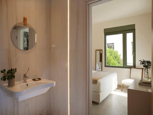 a bathroom with a sink and a mirror at Magnificent Crete Villa 4 Bedrooms Villa Ánthos Two Large Private Pools & Jacuzzi Bbq Close To The Beach Rethymno in Prínos