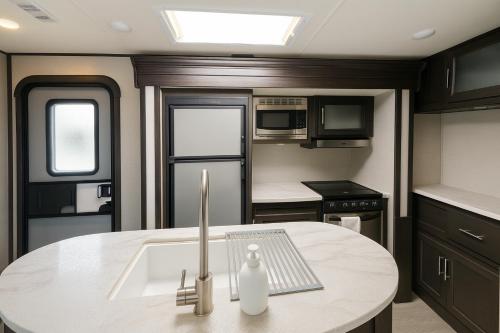 a kitchen with a sink and a counter top at The Kodiak-Walk to Oaklawn & Bathhouses Downtown Hot Springs in Hot Springs