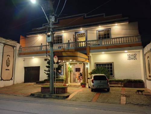a car parked in front of a house at night at Hotel Girasol Inn Barranquilla in Estación El Salto