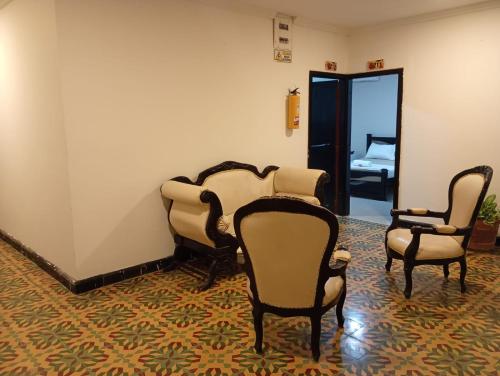 a room with chairs and a room with a bedroom at Hotel Girasol Inn Barranquilla in Estación El Salto