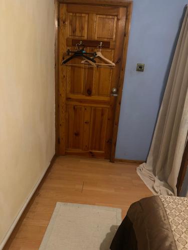 a bathroom with a wooden door with a sink in it at Sweet home in Moffat