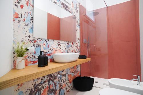 a bathroom with a sink and a mirror at Mama suites Politeama in Palermo