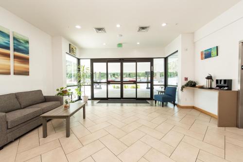 a living room with a couch and a table at Oyster Bay Inn & Suites in Bremerton