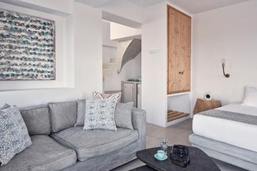 a living room with a couch and a bed at Luxury Santorini Villa Villa Elysian Pente Private Pool 2 Bedrooms in Foinikiá