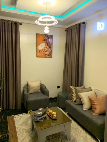 a living room with two couches and a coffee table at Luxury one bedroom apartment in Lagos