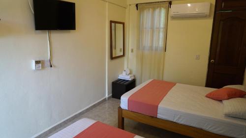 Una cama o camas en una habitación de Bacanda Hotel