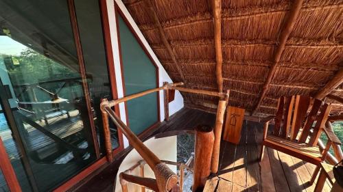 a room with two chairs and a glass window at Hotel Aldea Maya in Valladolid