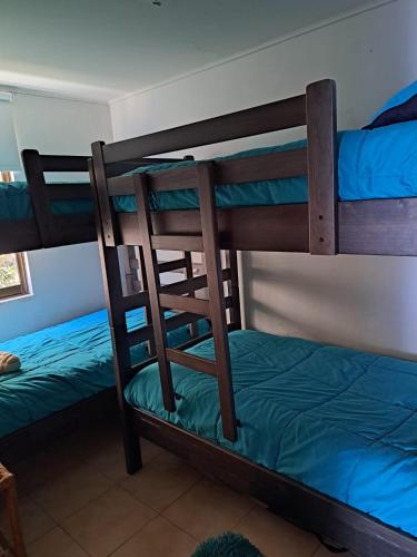 a couple of bunk beds in a room at Playa Amarilla Concon in Concón