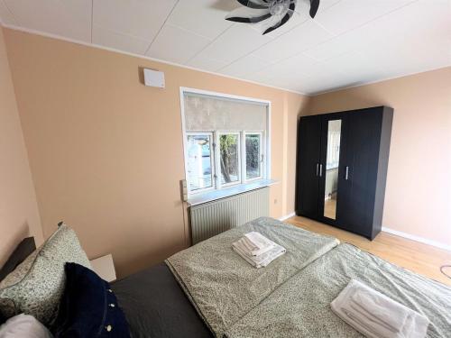 a bedroom with a bed and a ceiling fan at Waves & Waterslides in Rødby