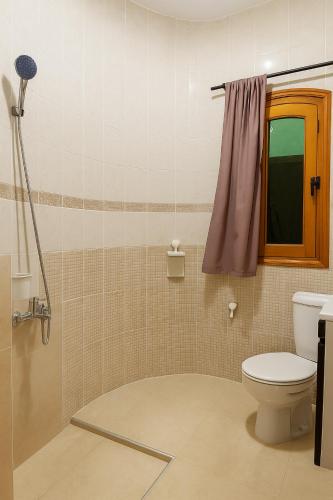 a bathroom with a toilet and a shower at Martil Oasis with Private Pool in Martil