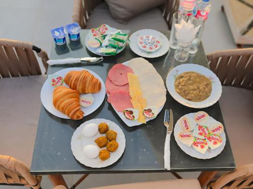 a table with plates of food on top of it at Amon Pyramids View Inn in Cairo