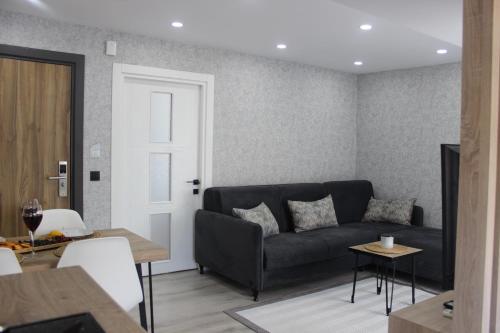 a living room with a couch and a table at Cosy Suite in Antalya