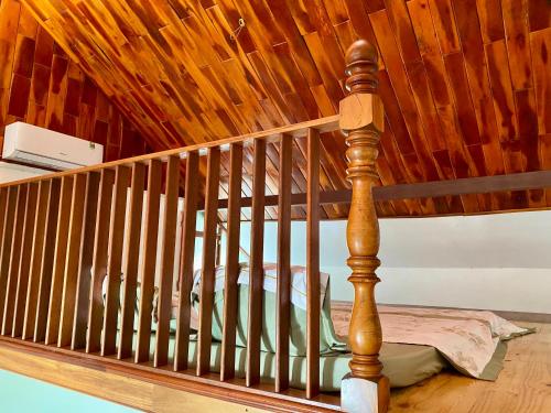 a wooden crib in a room with a wooden ceiling at An Bình Home in Ha Tien