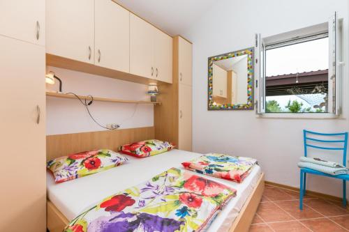 a bedroom with a bed and a mirror and a chair at Apartments by the sea Cove Donja Kruscica - Donja Krusica, Solta - 11146 in Grohote