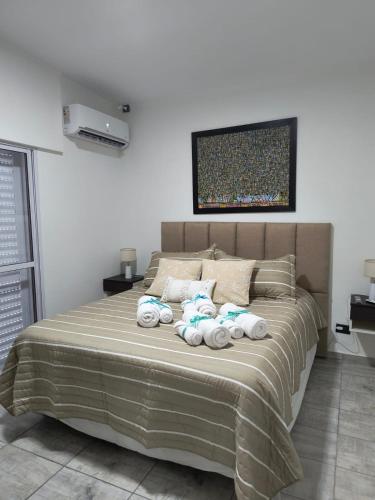 a bedroom with a bed with four towels on it at DS confort in General Pico