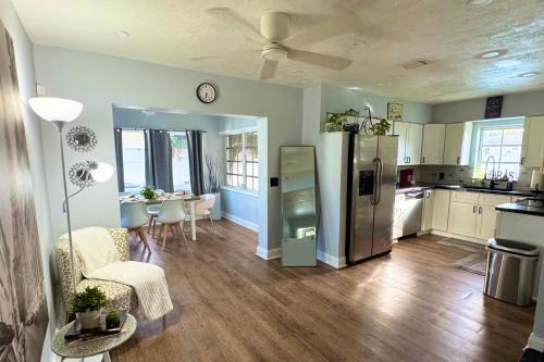 a kitchen with a stainless steel refrigerator and a table at Cozy Retreat, Families, Digital Nomads & Retirees in Pompano Beach
