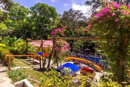 a garden with a playground and a water slide at MINCA Chunuu - glamping - coworking MINCA in Minca