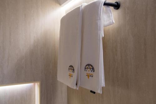 two towels hanging on a towel rack in a bathroom at في كامب الهدا v camp in Taif