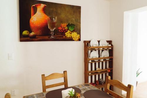 a dining room with a table and a vase on the wall at Beatiful aparment in the magical town of Orizaba 5 in Orizaba