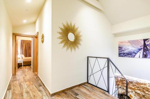 a hallway with a staircase and a mirror on the wall at Fantastic Seafront Villa 4 Bedrooms Villa Samostan Prestige Stunning Sea Views & Enclosed Garden With Private Pool Korcula in Korčula