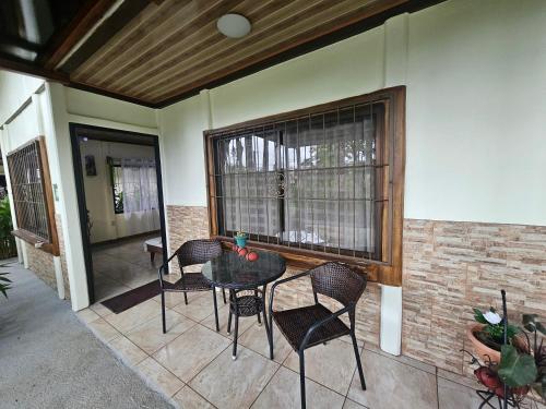 a patio with a table and chairs and a window at Hormiga's Houses in Fortuna
