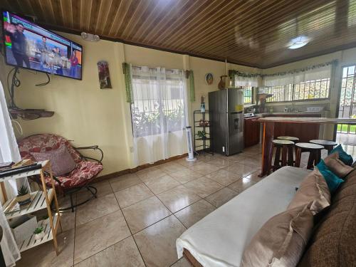 a living room with a couch and a kitchen at Hormiga's Houses in Fortuna