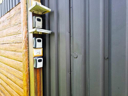 a metal wall with a bunch of boxes on it at Hormiga's Houses in Fortuna