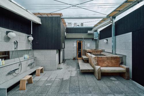 a bathroom with sinks and benches in a building at HOTEL Inc in Kyoto