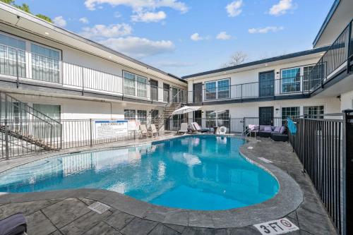 a swimming pool in front of a building at West U Studio, Near Med Center, Stadiums & Zoo in Houston