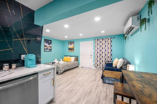 a kitchen and living room with blue walls at West U Studio, Near Med Center, Stadiums & Zoo in Houston