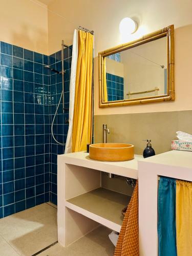 a bathroom with a sink and a mirror at Studio Indigo in Aljezur