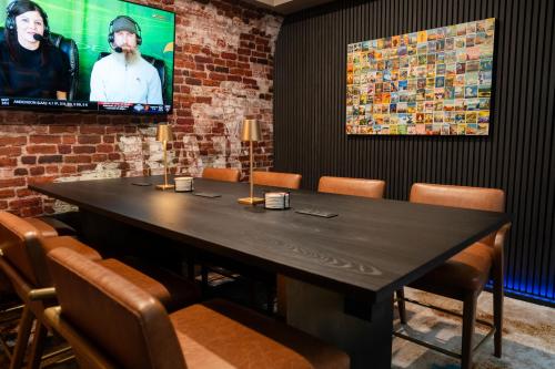 a dining room with a black table and chairs at Kansas City Marriott Downtown in Kansas City