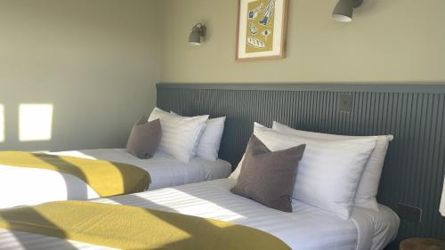 two beds sitting next to each other in a room at The Elmwood Motel in Christchurch