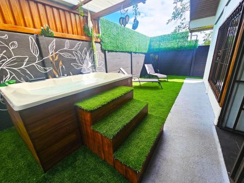 a bathroom with a bath tub and grass at Hormiga's Houses in Fortuna