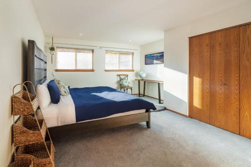 a bedroom with a bed and a wooden cabinet at 14 Person Adventure Oasis with Hotub in Wenatchee