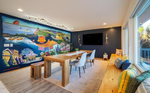 a dining room with a table and a large mural at 14 Person Adventure Oasis with Hotub in Wenatchee