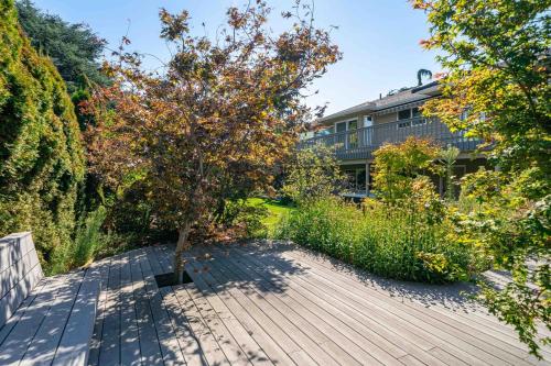 a tree on a wooden walkway in front of a building at 14 Person Adventure Oasis with Hotub in Wenatchee