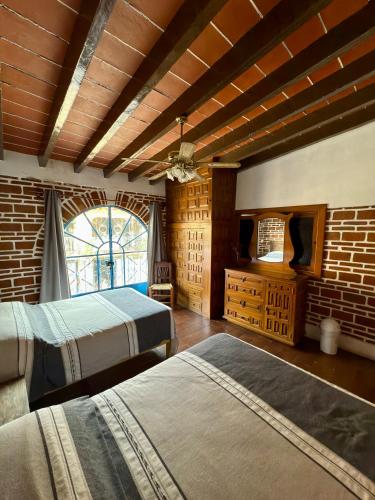 Una cama o camas en una habitación de Posadita Lui de Tepoztlán
