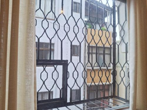 a view of a window with a iron gate at 山露露品茶 70年代老房子 二樓背包 4-5樓合併 六人包層 Te en Te' Guesthouse in Tainan