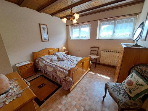 a bedroom with a bed and a chair in it at Holiday Home in Reipertswiller near Castle in Reipertswiller