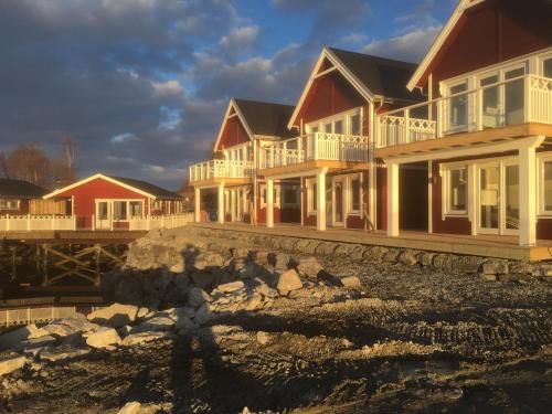 a person standing in front of a row of houses at Garsnes Brygge in Sjøvegan