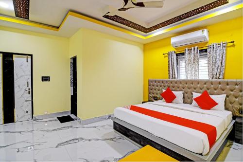 a bedroom with a large bed with red pillows at Hotel O SRI SAI PALACE in Bārang