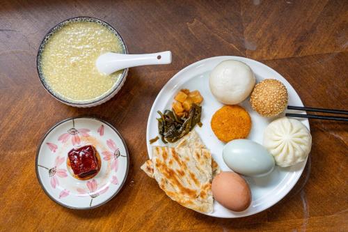 a plate with eggs and other food on a table at JOYSEA HUT in Yantai