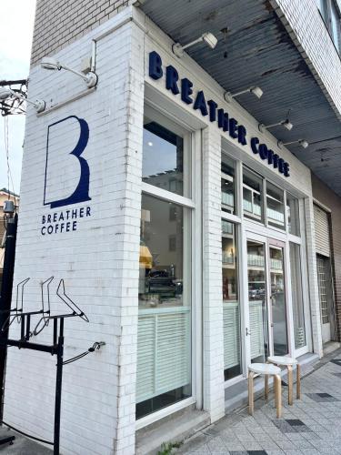 a white brick building with abaiter coffee sign on it at Marina blue zushi in Zushi