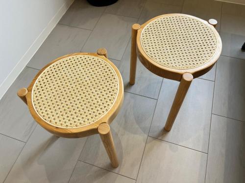 two wooden chairs sitting on a tile floor at Marina blue zushi in Zushi