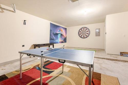 a ping pong table in the middle of a room at Gorgeous 2story Home with 4 bedrooms in Buda